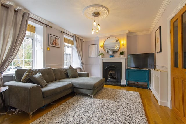 A generous dual aspect reception room with a feature cast iron fireplace with granite hearth and open grate.