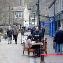 People sit outside bars and cafes at Hebden Bridge, as Covid 19 restrictions are relaxed..12th April 2021..Picture by Simon Hulme 