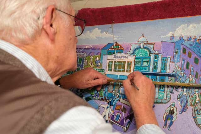 Artist Joe Scarborough working on his latest projects on his boat in Sheffield Canal Basin.