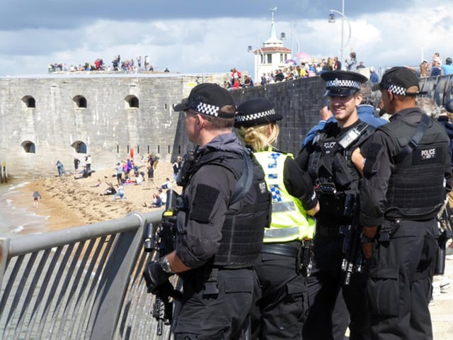Police at the Hot Walls in Old Portsmouth as people watched HMS Queen Elizabeth arriving back into Portsmouth. Picture: Karina Hill