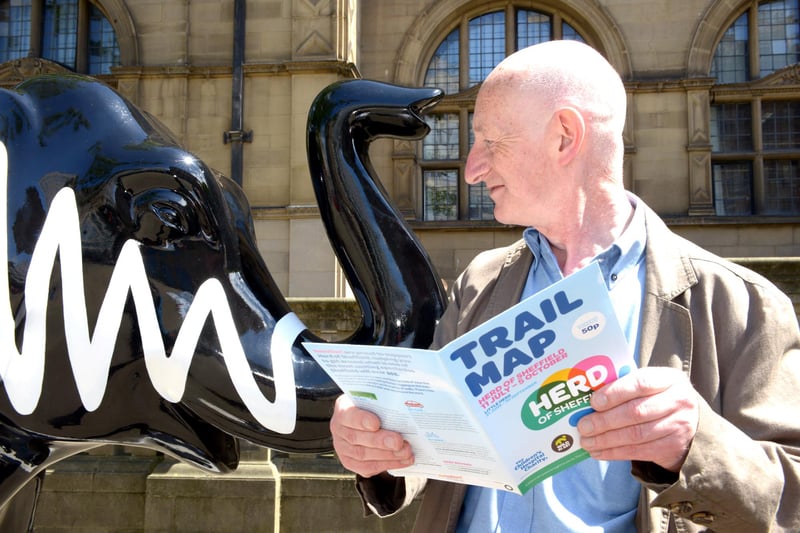 John Woolley studies the Herd trail map with the Arctic Monkeys elephant in its original spot outside the Town Hall at the launch of the Herd of Sheffield trail