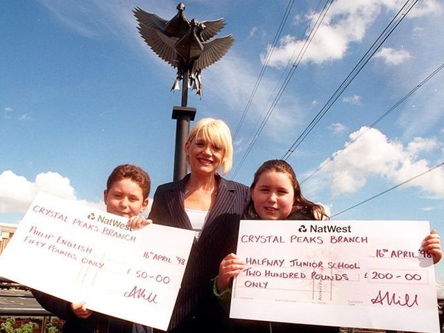 Actress Michelle Collins officially opened the new Drakehouse Retail Park and is pictured here with competition winners, Philip and Rebecca English, who named the sculpture in the background, on April 16, 1998