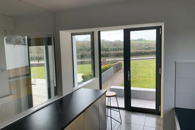 The kitchen has a floor to ceiling window and door to the front allowing access onto the garden.