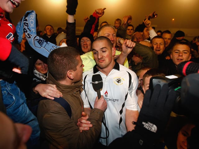 Scorer Peter Knox is interviewed by ITV's Dave Beckett on the pitch.