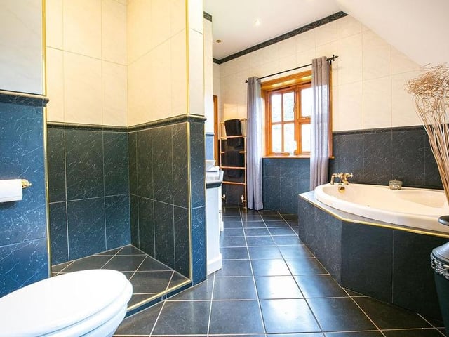An impressive, large en suite bathroom to the main bedroom. It has a raised spa bath, walk-in shower and a design that can only be appreciated in person.