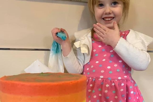 Becki Yeoman sent this photo of her youngest daughter helping her to make a birthday cake for her eldest daughter. She said it was rainbow inspired to suit the current situation.