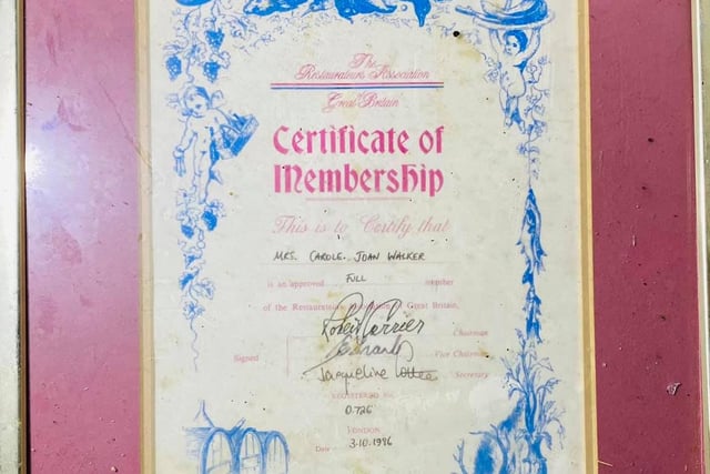 A framed membership certificate left behind.