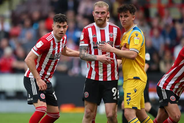 John Egan and Oli McBurnie of Sheffield United with Tom McIntyre of Reading last season: Simon Bellis / Sportimage