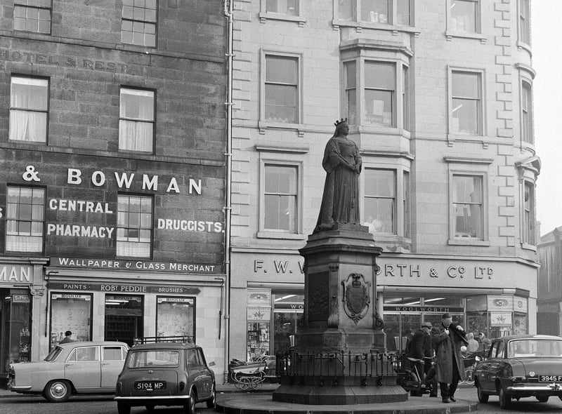 The Queen Victoria statue at the foot of Leith Walk is pictured in 1964. The businesses surrounding it included a department store, a pharmacy and a home decoration shop.