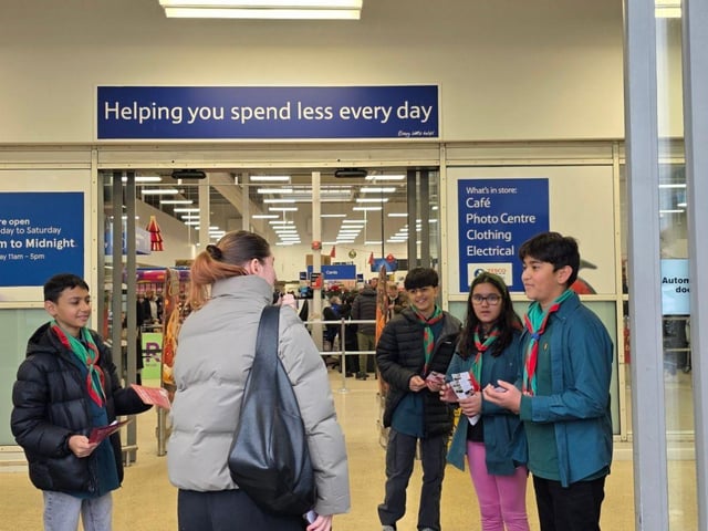 Scouts in action: handing out leaflets and sharing food bank shopping lists with Tesco shoppers.