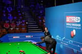 Yan Bingtao of China plays a shot during the 2021 Betfred World Snooker Championship (photo by Zac Goodwin - Pool / Getty Images).