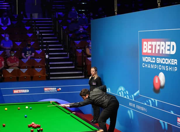 Yan Bingtao of China plays a shot during the 2021 Betfred World Snooker Championship (photo by Zac Goodwin - Pool / Getty Images).
