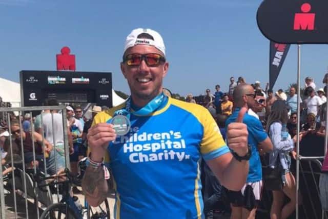 Determined dad Dan Faulkner has completed a grueling Ironman challenge in memory of son Jack, from Totley. He is pictured with his medal, in his Sheffield Children's Hospital charity T-shirt