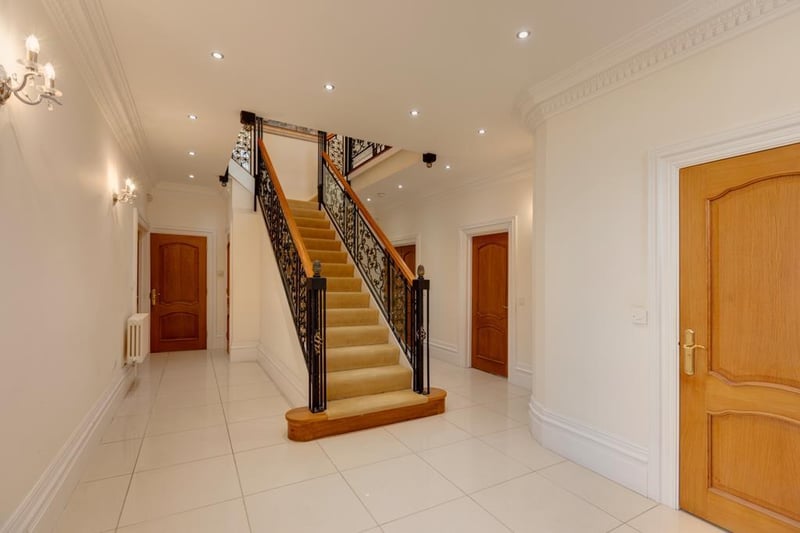 A grand entrance hall with a side facing UPVC double glazed sash window, coved ceiling, recessed lighting, wall mounted light points, central heating radiators, deep skirtings and Porcelanosa tiled flooring. Oak doors open to the WC, study, living kitchen and two storage cupboards. Double oak doors also open to the drawing room and lounge.