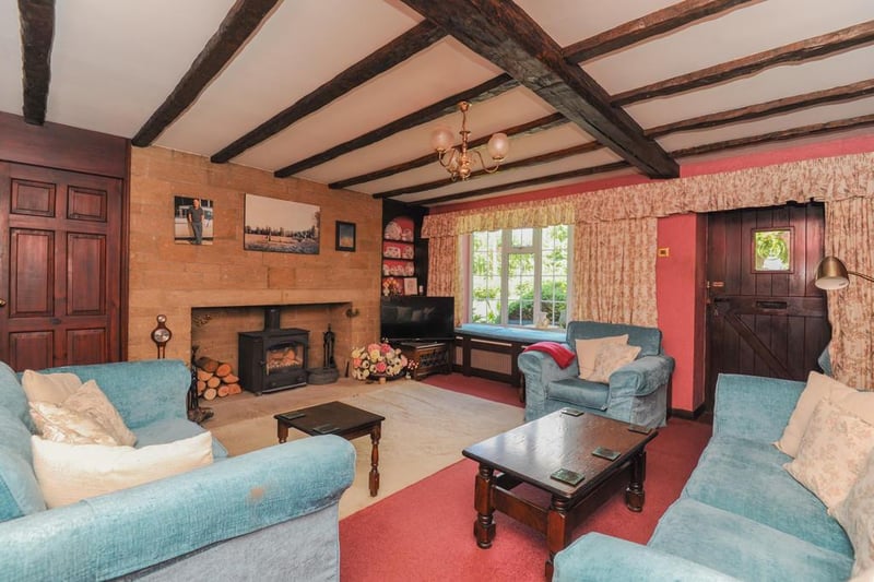The property has a spacious lounge with feature fireplace and log-burning stove.