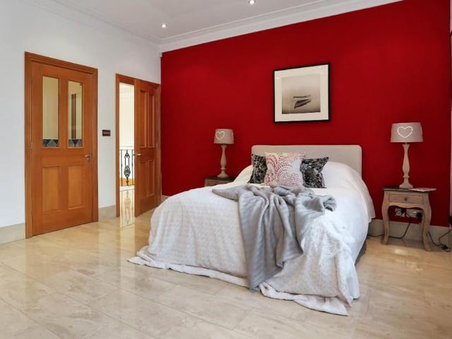 Another large double bedroom with a well-designed, fitted wardrobe and en suite WC. There are two uPVC double-glazed windows at the back.