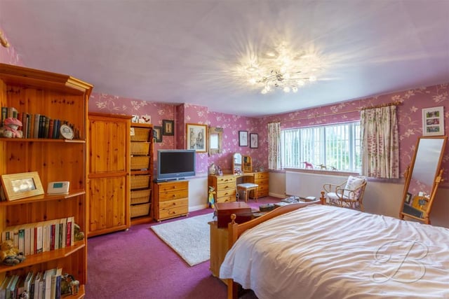 Upstairs now and a look at the main bedroom. It has a carpeted floor, central-heating radiators, a fitted wardrobe, a window to the front and access to an en suite.