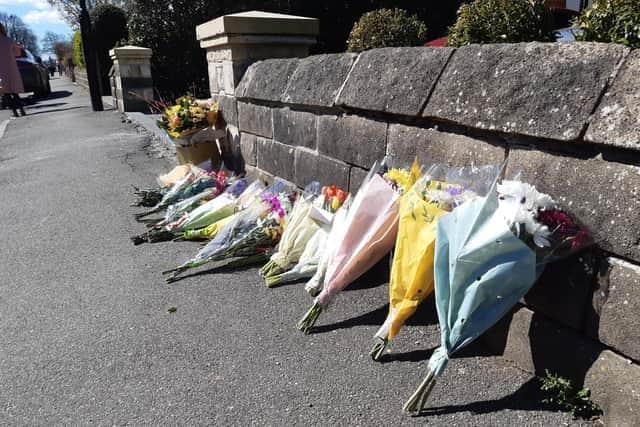 Tributes left to Marcia Grant, the well-loved grandmother who died after being struck by a car outside her home on Hemper Lane, Greenhill