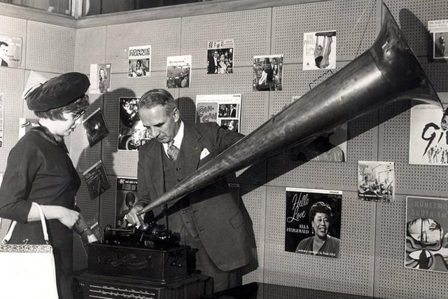 Miss Celia Lane, Festival Shopping Queen, with Mr F.T.Fair and an old phonograph, at Wilson Peck Limited, November 11,  1961