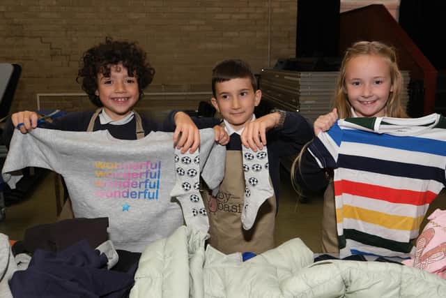 Pupils at St Marie's Catholic primary in Fulwood package clothes for kids in Afghanistan through the Baby Basics program