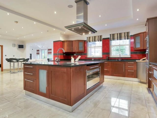 The dining kitchen is so big and bright, we need a second look at it. There is a built-in microwave, a further electric oven and grill, two wine-coolers, and space for an American-style fridge freezer, washing machine and coffee machine, while the dining area provides ample space for a large table.