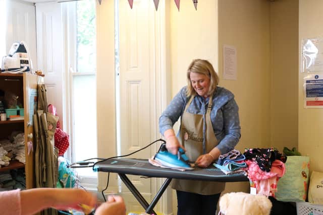 Volunteer Paula Stacey at the ironing board