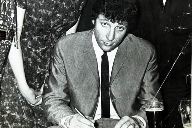 Tom Jones signs autographs for fans when he popped into the Rawmarsh Trades and Labour Club while appearing at the Rawmarsh Baths Hall