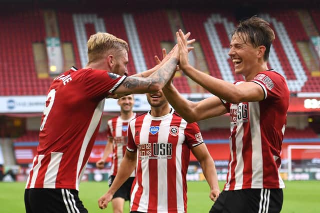 Oliver McBurnie of Sheffield United celebrates with Sander Berge (R) after scoring his team's third goal during the Premier League match between Sheffield United and Tottenham Hotspur at Bramall Lane: Oli Scarff/Pool via Getty Images