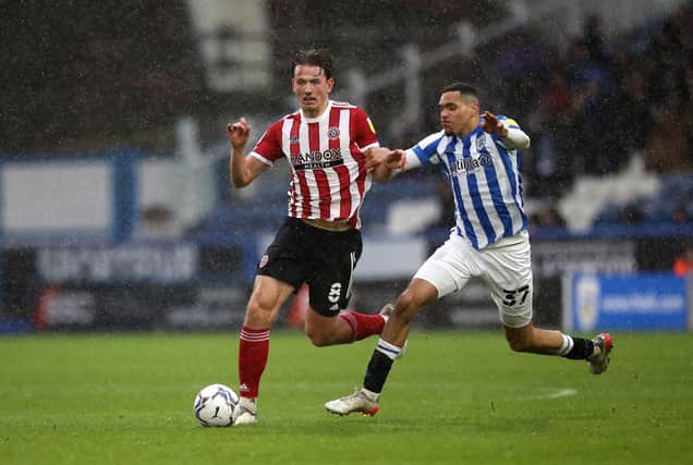 Sheffield United's Sander Berge (left) and Huddersfield Town's Jon Russell battle for the ball: Isaac Parkin/PA Wire.