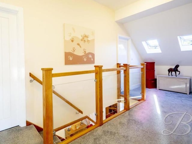 At the top of the staircase awaits this lovely landing, which leads to all four bedrooms. It has two Velux roof windows to the front, and also an air-conditioning/hot water unit.
