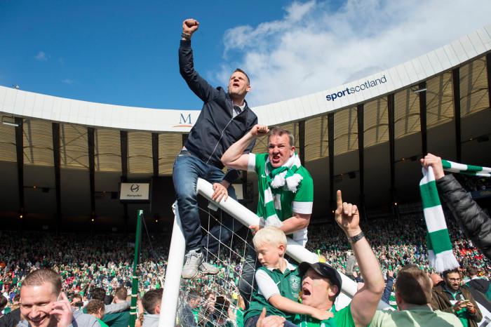 Hibs fans' excitement boiled over as they raced onto the pitch at full-time - damaging the Hampden pitch and goal in the process. Picture: SNS