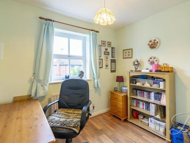 The smallest of the four bedrooms is also versatile. The window overlooks the back of the house.