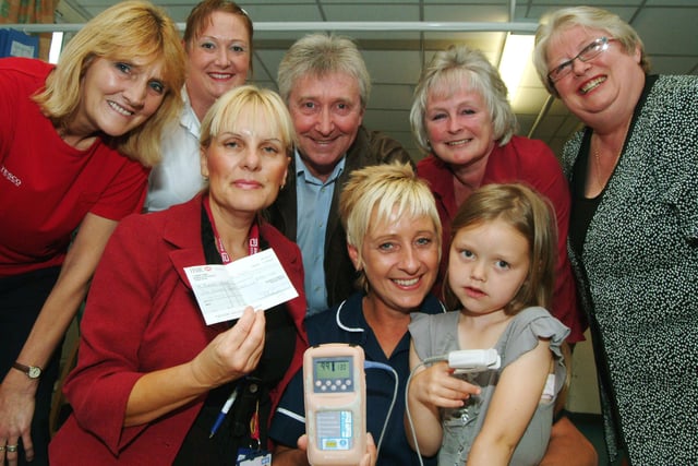 In 2009 Mansfield Hospital Theatre Troupe presented £500 to Kings Mill Hospital's Blandy Ward on Tuesday, some of the proceeds from their production of Mother Goose. Debbie Wilson, centre left, Specialist Nurse presents the cheque to Ward Leader Deb Farn, centre and patient Megan Clarke, left aged 6 of Mansfield Woodhouse for the purchase of a Hand Held Sats Machine watched by Troupe Members, from back left; Jackie Jessops, Donna Dillon, Trevor Morley, June Morley and Jill Broome.