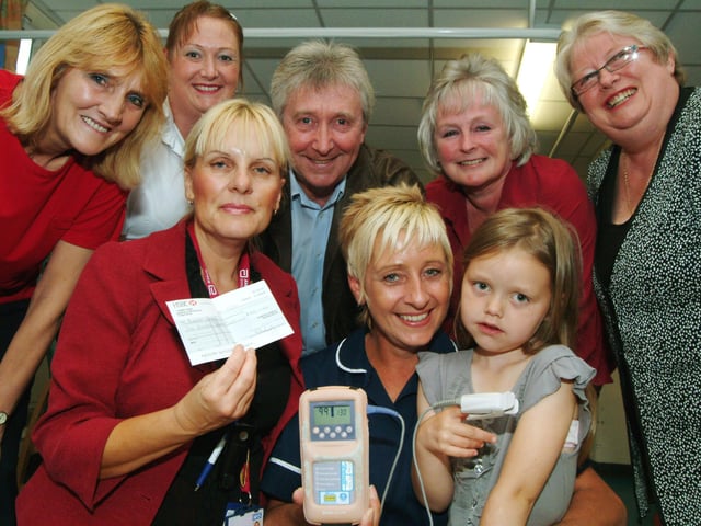In 2009 Mansfield Hospital Theatre Troupe presented £500 to Kings Mill Hospital's Blandy Ward on Tuesday, some of the proceeds from their production of Mother Goose. Debbie Wilson, centre left, Specialist Nurse presents the cheque to Ward Leader Deb Farn, centre and patient Megan Clarke, left aged 6 of Mansfield Woodhouse for the purchase of a Hand Held Sats Machine watched by Troupe Members, from back left; Jackie Jessops, Donna Dillon, Trevor Morley, June Morley and Jill Broome.
