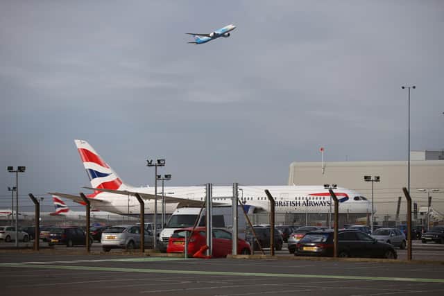 LONDON, ENGLAND - FEBRUARY 13: A plane takes off in view of a British Airways aeroplane at Heathrow Airport on February 13, 2021 in London, England. From 15 February travellers to the UK from a country on the UK's travel ban "red list" will be required to quarantine in a government-approved facility for ten days at their own cost. (Photo by Hollie Adams/Getty Images)