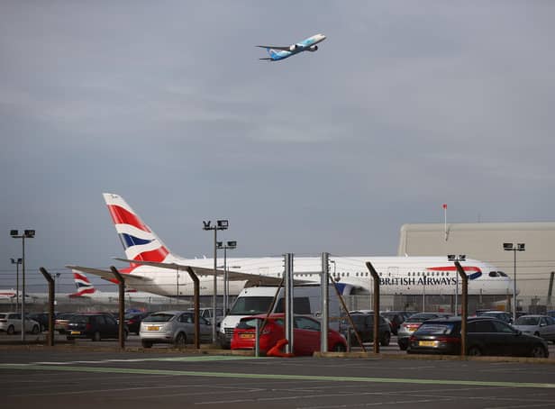 LONDON, ENGLAND - FEBRUARY 13: A plane takes off in view of a British Airways aeroplane at Heathrow Airport on February 13, 2021 in London, England. From 15 February travellers to the UK from a country on the UK's travel ban "red list" will be required to quarantine in a government-approved facility for ten days at their own cost. (Photo by Hollie Adams/Getty Images)