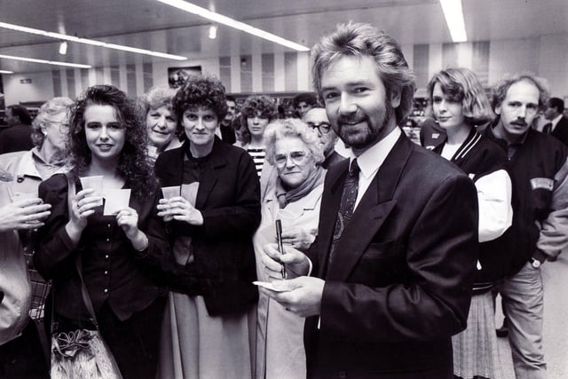 Noel Edmunds signs autographs while customers try his new spring water at Sainsburys, Crystal Peaks... October 1990