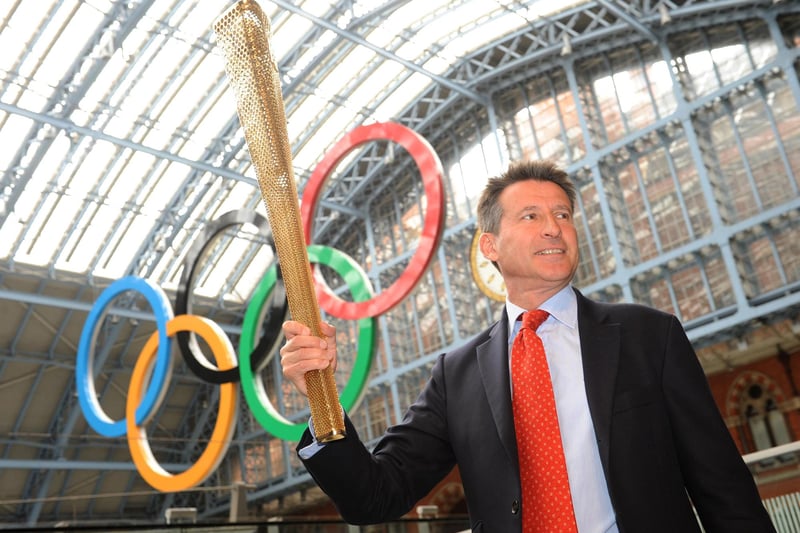 London 2012 Olympics chairman Lord Coe holds aloft the Olympic Flame, the new golden torch carried by the 8,000 runners on the London 2012 torch relay, at St Pancras Station in London. Seb, from Sheffield, won gold in the 1500 metres at Moscow in 1980 and Los Angeles in 1984 and silver in the 800 metres race at both championships.