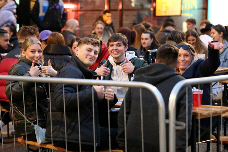 A group of friends react for the camera while drinking in outdoor seating areas in Manchester's Northern Quarter on April 16, 2021 in Manchester, England. (Photo by Charlotte Tattersall/Getty Images)