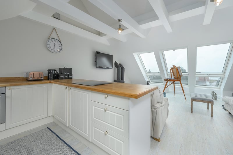 The annexe kitchen/living area, which benefits from beautiful coastal views over the rear garden.
