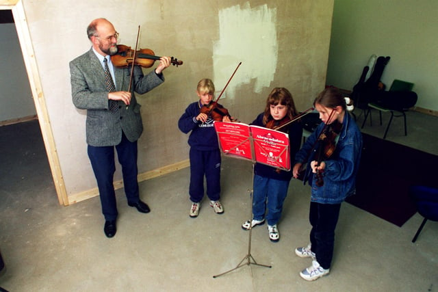 An impromptu music lesson for children in the nearly finished classroom built by parents and staff at Loxley Primary school in 1996