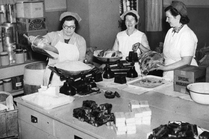 Weighing in the storeroom at a large school meals cooking centre in Sheffield, 1940-1959. Ref no: s34717