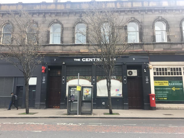 Masked person pictured walking past The Central Bar, Leith Walk, Edinburgh, which is currently closed with blinds firmly down during the coronavirus outbreak
