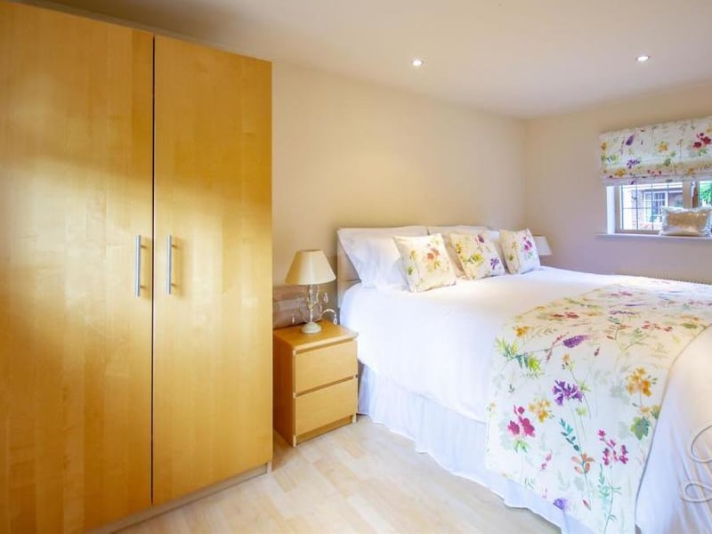 One of two bedrooms inside the annexe. Cosy and comfortable, it has laminate flooring and a central-heating radiator.