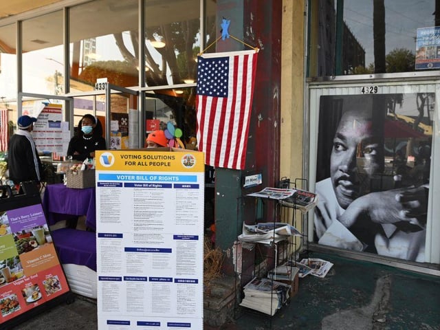 People arrive to cast their ballot in the US presidential election at a vote center in the Hot & Cold Cafe in the Leimert Park neighborhood of Los Angeles, California.