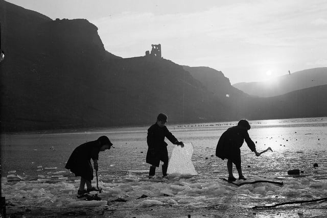 Three boys breaking up the ice on St Margaret's Loch in Holyrood Park in the winter of 1959.