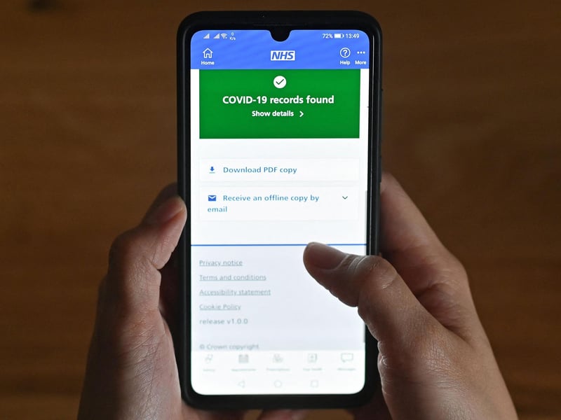 A smartphone screen displaying a Covid-19 vaccine record on the National Health Service app. Picture: JUSTIN TALLIS/AFP via Getty Images