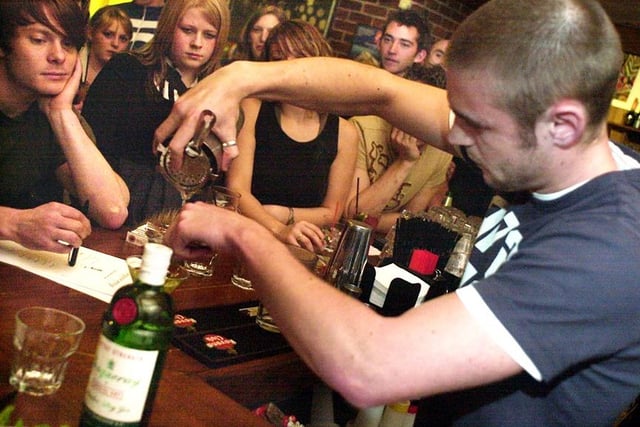Ian Bowan of Halcyon is watched by Andy Rogers (left), one of the judges in the cocktail competition at Menzel's Wine Bar, Ecclesall Road, Sheffield, in 2003