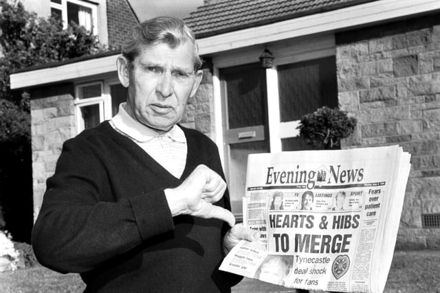 Holding a copy of the Evening News newspaper, Eddie Turnbull, former manager of Hibernian football club, gives the 'thumbs down' to Wallace Mercer's proposed Hearts & Hibs merger.