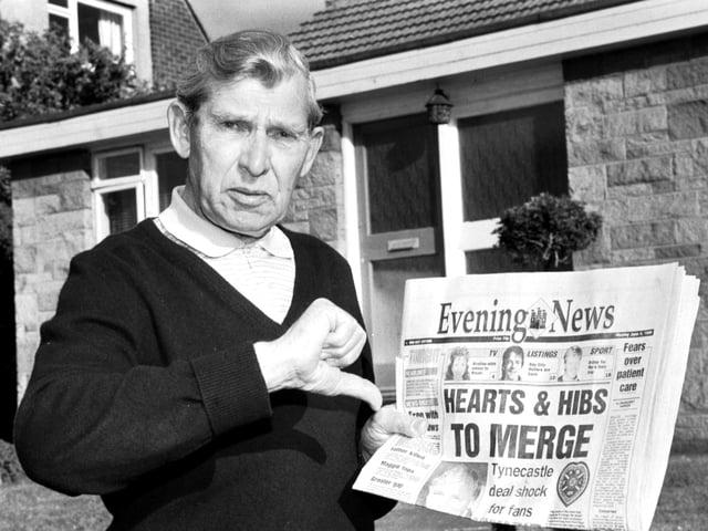 Holding a copy of the Evening News newspaper, Eddie Turnbull, former manager of Hibernian football club, gives the 'thumbs down' to Wallace Mercer's proposed Hearts & Hibs merger.